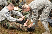 U.S. Air Force Reserve Chief Master Sgt. Kimberly Lord, superintendent, 913th Airlift Group, assists Chief Master Sgt. Scotty Rodgers, deputy superintendent, 913th Maintenance Squadron, remove his overboots Nov. 4, 2017, at Little Rock Air Force Base, Ark.