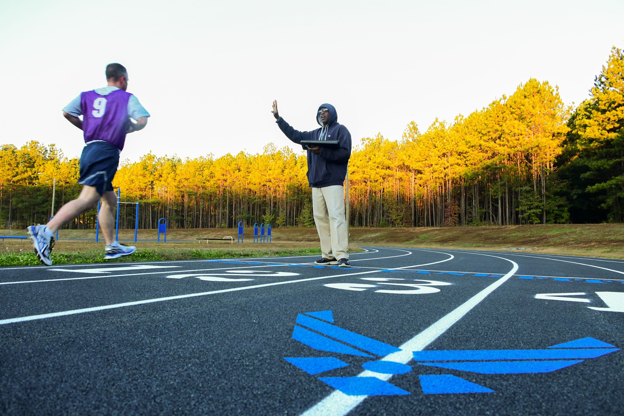 Kenneth Duhart, 94th Airlift Wing exercise physiologist, right, tells a runner his time during a physical fitness test at the Dobbins Air Reserve Base track Oct. 30, 2017. The track was closed for about a month as crews worked to have it repaved and restriped. (U.S. Air Force photo/Staff Sgt. Andrew Park)