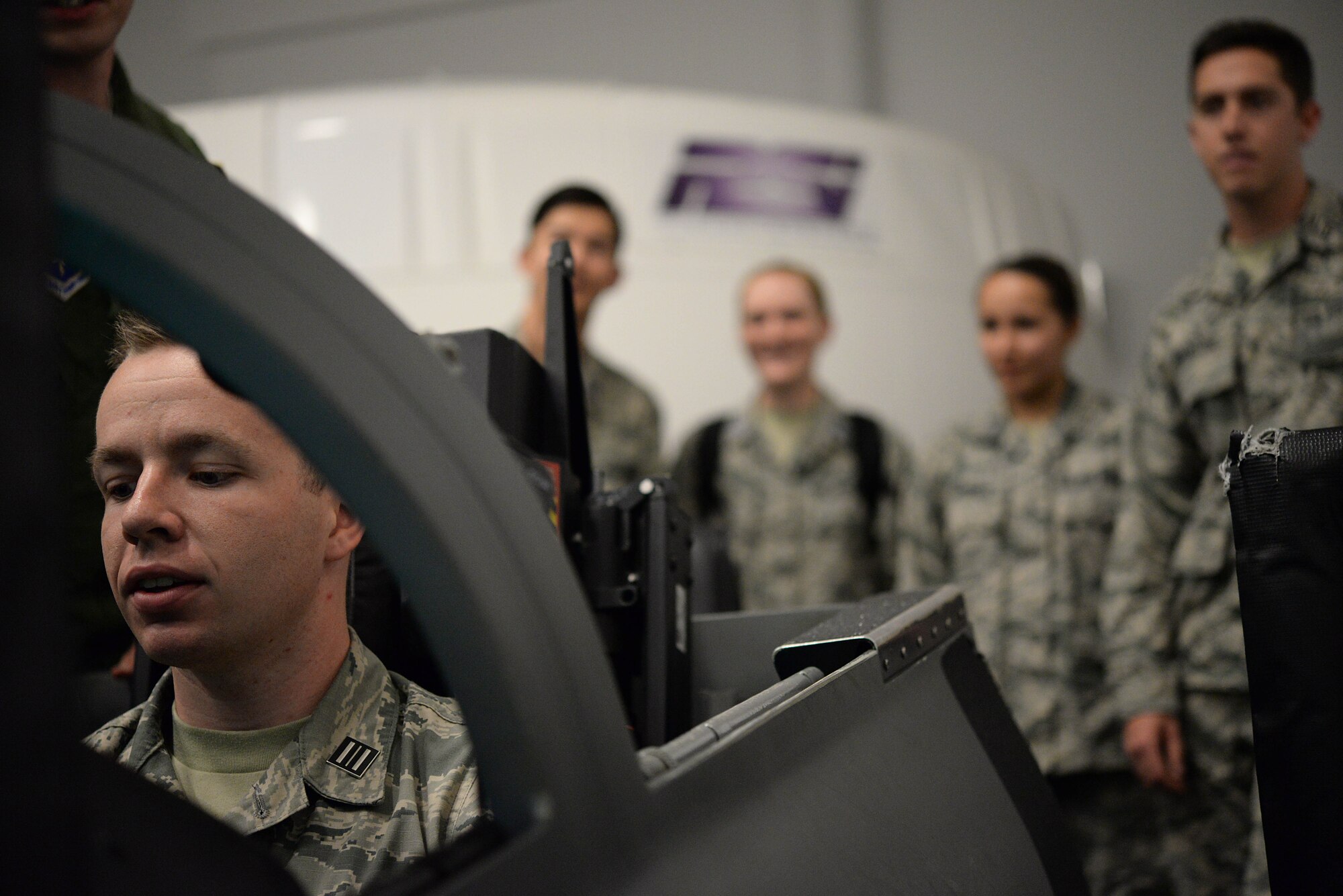 Cadets take turns flying in T-38 Talon simulators during a base tour Nov. 3, 2017, on Columbus Air Force Base, Mississippi. At the end of the tour the seniors of the class were given pieces of paper with facts about another cadet in the detachment. The seniors had to find the correlating cadet who then gave the seniors the Air Force Specialty Code they each will prepare to move to. (U.S. Air Force photo by Airman 1st Class Keith Holcomb)
