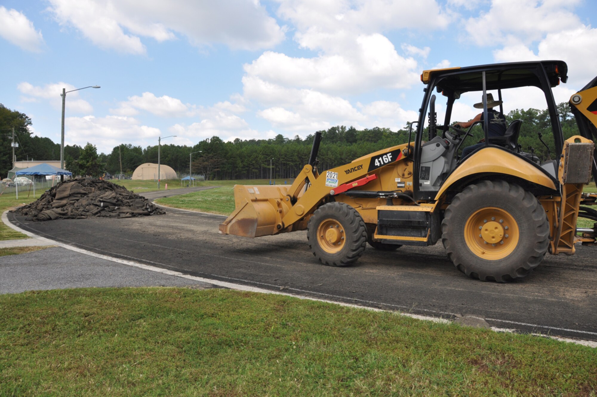 A contractor uses a front end loader to remove the surface of the track at Dobbins Air Reserve Base, Ga. Sept. 27, 2017. The renovation process lasted about a month as crews worked quickly to have it repaved and restriped. (U.S. Air Force photo/Master Sgt. James Branch)