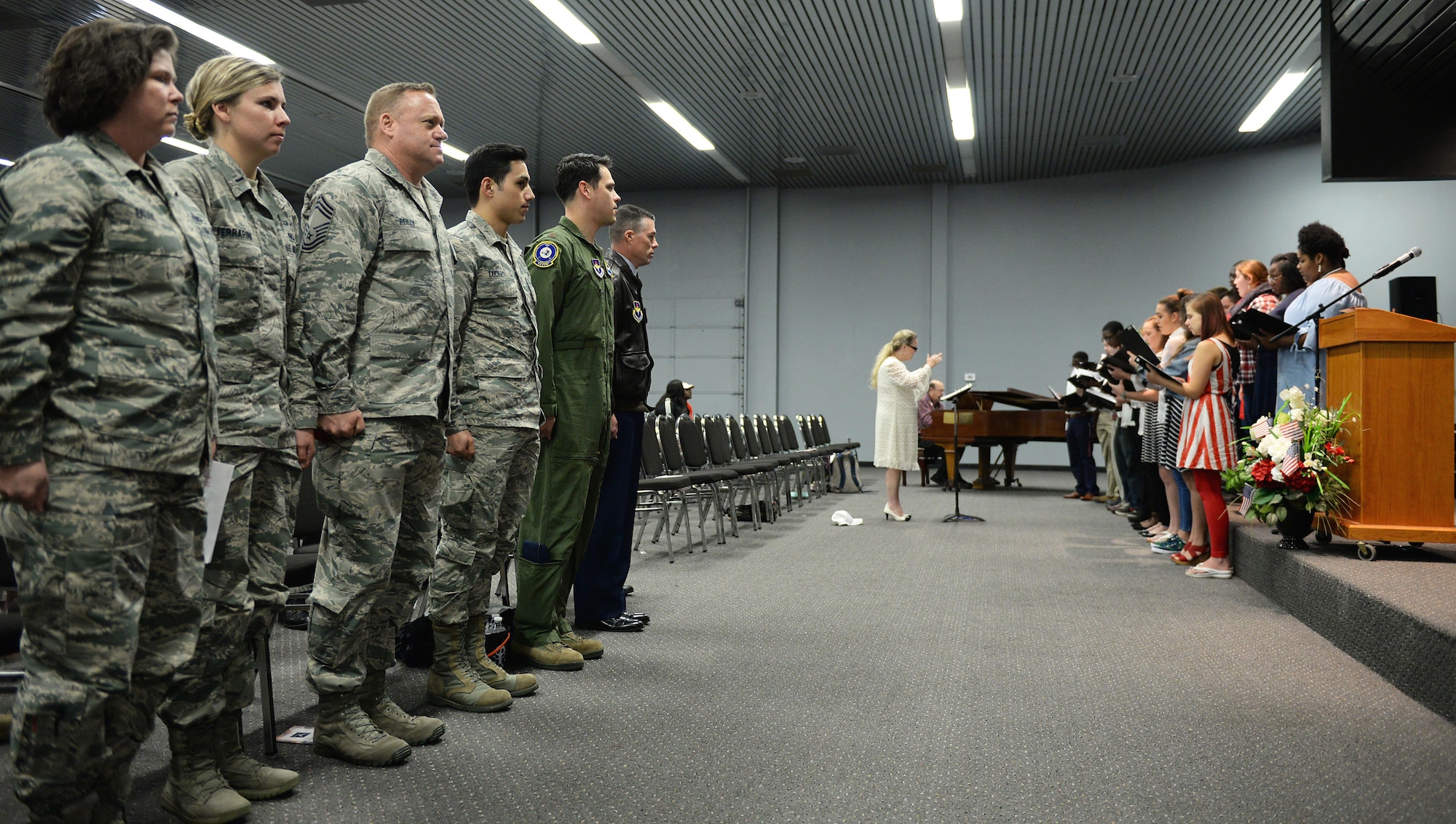 Airmen from Columbus Air Force Base, Mississippi, stand during the Air Force song Nov. 7, 2017, at the East Mississippi Community College campus in Mayhew, Mississippi. The choir sang before Col. Douglas Gosney, 14th Flying Training Wing Commander, spoke at the ‘Proud to be an American’ event. (U.S. Air Force photo by Airman 1st Class Keith Holcomb)