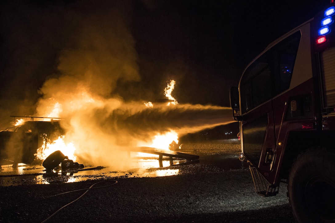 Water shoots out of a firetruck’s turret during nighttime live-fire training, Nov. 8, 2017, at Moody Air Force Base, Ga. This training is an annual requirement for Moody firefighters and is just one of the ways they stay ready to protect people, property and the environment from fires and disasters. (U.S. Air Force photo by Senior Airman Janiqua P. Robinson)