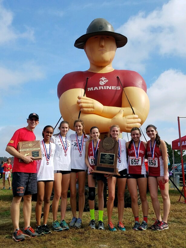 Ravenwood High School’s girls’ cross country team stands in front of an inflatable Marine drill instructor at Percy Warner Park Steeplechase Course in Nashville, Tennessee, Nov. 4, 2017. They are the Tennessee Secondary School Athletic Association State Cross Country Champions of Division 1 Large. (U.S. Marine Corps courtesy photo)