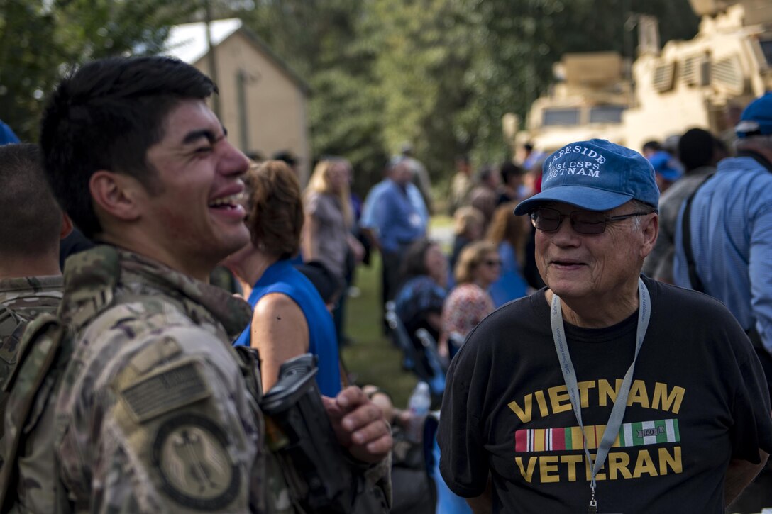 Ken Groom, retired Safeside member, and a member of the 823d Base Defense Squadron share a laugh after a capabilities demonstration, Nov. 8, 2017, at Moody Air Force Base, Ga. Safeside reunions are biennial and scheduled around the 820th Base Defense Group’s high-ops tempo. (U.S. Air Force photo by Senior Airman Daniel Snider)