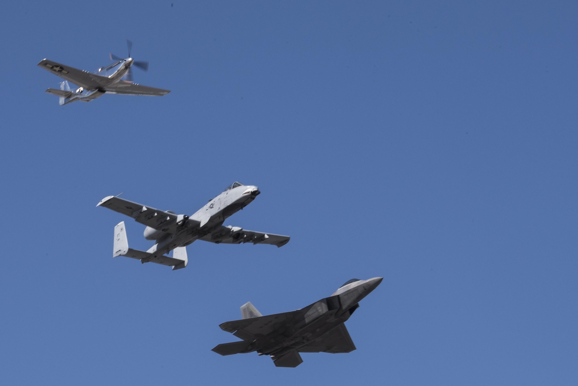 A P-51 Mustang, an A-10C Thunderbolt II and a F-22 Raptor perform a heritage flight during the Naval Air Station Jacksonville Air Show, Nov. 3, 2017, at NAS Jacksonville, Nov. 3, 2017, at NAS Jacksonville, Fla. The U.S. Air Force Heritage Flight program showcases past, present and future aircraft to spectators at air shows around the world. (U.S. Air Force photo by Staff Sgt. Eric Summers Jr.)