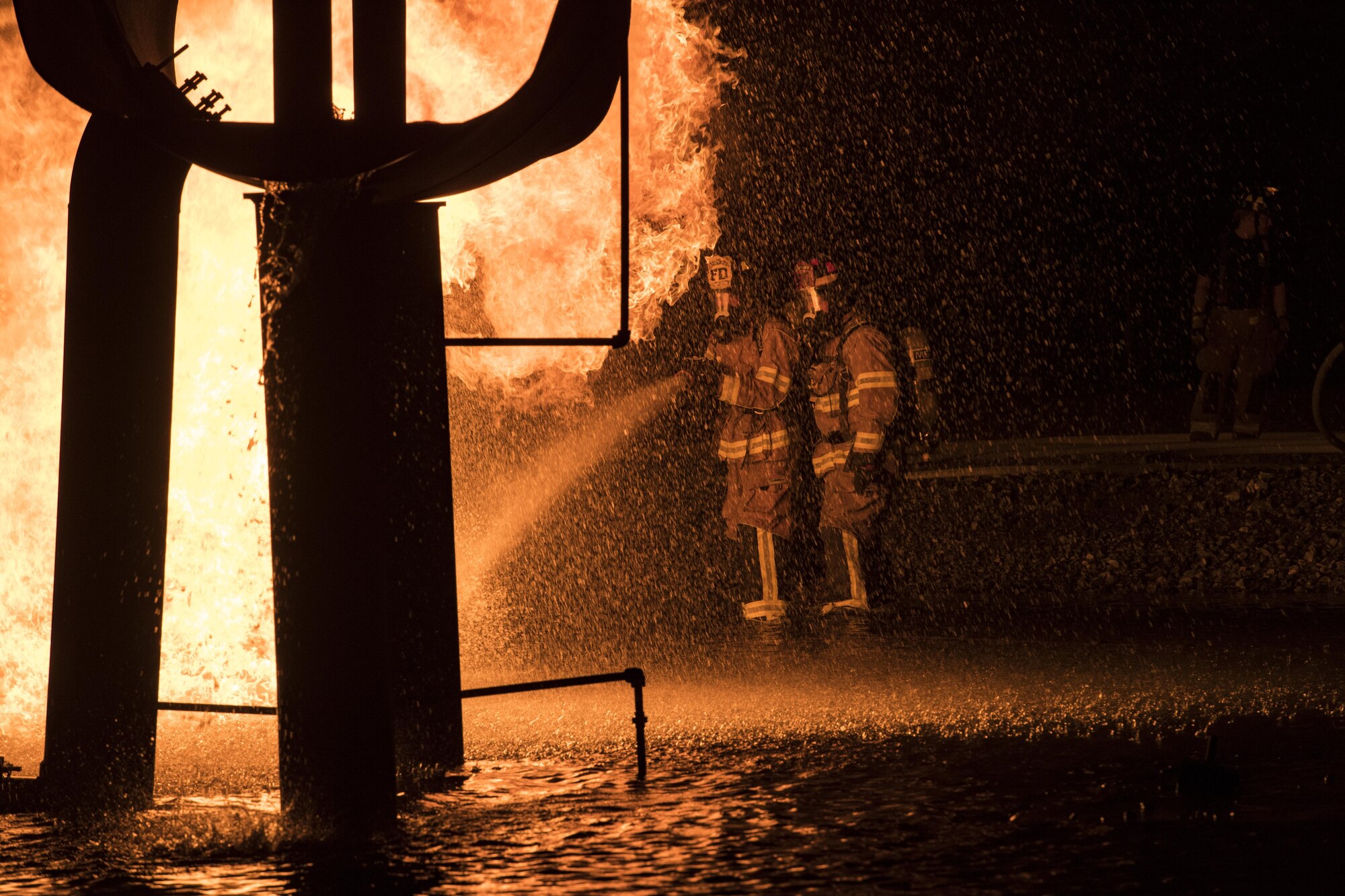 Firefighters from Moody Air Force Base, Ga. put out a blaze during nighttime live-fire training, Nov. 9, 2017, at Moody AFB, Ga. This training prepares participants for the possibility of nighttime aircraft fire operations. (U.S. Air Force photo by Senior Airman Janiqua P. Robinson)
