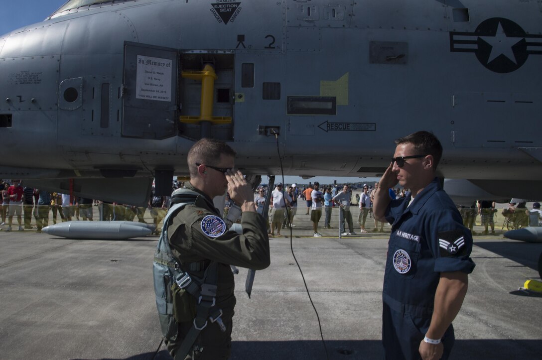 Senior Airman Michael Atkinson, A-10 Heritage Flight Team crew chief, salutes Maj. Joseph Morrin, A-10 Heritage Team pilot, Nov. 4, 2017, at Naval Air Station Jacksonville, Fla. The U.S. Air Force Heritage Flight program showcases past, present and future aircraft to spectators at air shows around the world. (U.S. Air Force photo by Staff Sgt. Eric Summers Jr.)