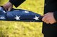 An Airmen folds a flag during a Safeside reunion memorial, Nov.8, 2017, at Moody Air Force Base, Ga. Biennially, the Safeside Association holds a reunion to interact with and honor their past and present comrades from the 820th Base Defense Group. (U.S. Air Force photo by Airman Eugene Oliver)