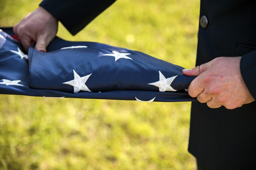 An Airmen folds a flag during a Safeside reunion memorial, Nov.8, 2017, at Moody Air Force Base, Ga. Biennially, the Safeside Association holds a reunion to interact with and honor their past and present comrades from the 820th Base Defense Group. (U.S. Air Force photo by Airman Eugene Oliver)
