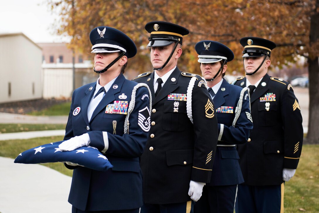 Idaho National Guardsmen carry and prepare to present the colors during a Veterans Day ceremony.