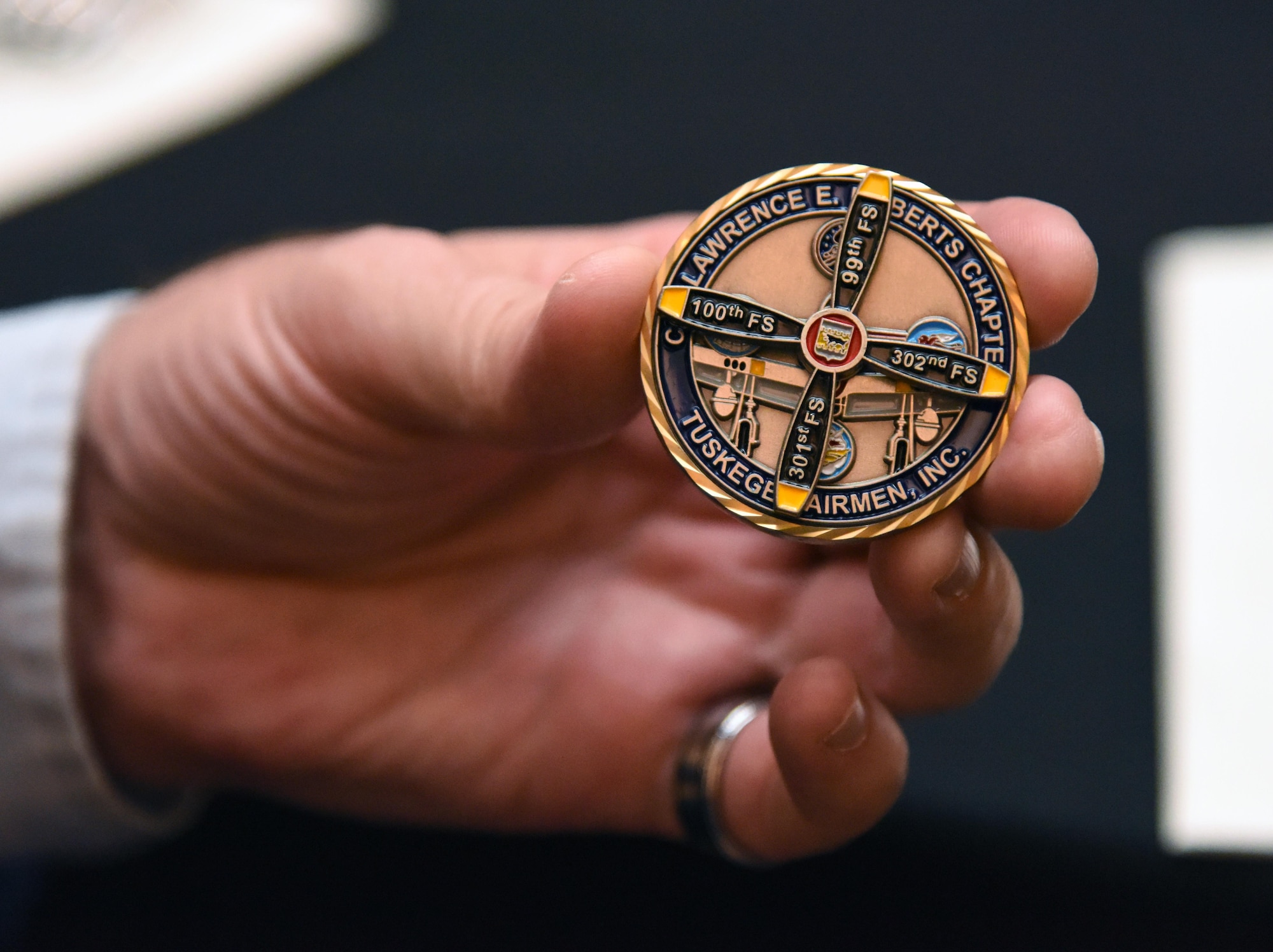 Lt. Col. Michael Manning, 81st Training Group deputy commander, displays a coin during the Tuskegee Airmen Inc. 8th Annual Benefit Gala at the Slavonian Lodge Nov. 4, 2017, in Biloxi, Mississippi. The event, which was held to raise funds for the Col. Lawrence E. Roberts Scholarships Fund, also included a silent auction and dinner. (U.S. Air Force photo by Kemberly Groue)