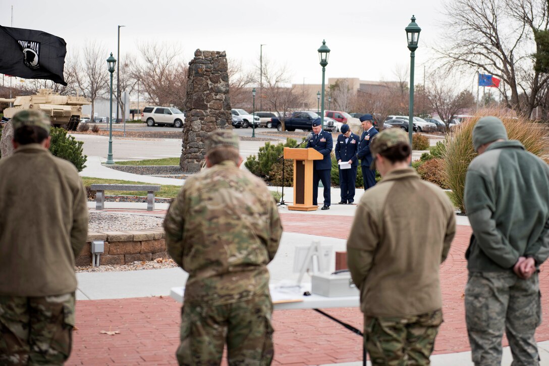 National Guardsmen bow their heads and pause for a moment of silence during a Veterans Day ceremony.