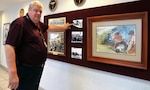 George Wunderlich, U.S. Army Medical Department Museum director, points to a section of historical photos and prints in the museum’s revamped AMEDD Regimental Room, which is used for various activities from change of command and retirement ceremonies to receptions to training demonstrations. The renovations to the room are part of several improvements being made at the museum to enhance the visitor experience.