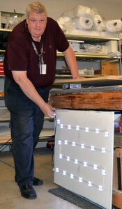 George Wunderlich, U.S. Army Medical Department Museum director, shows a new LED lighting system that is going to be installed in new exhibit cases at the museum. The LED lighting system is being designed by AMEDD museum specialists Christopher Goodrow and Angelique Kelley. The new lighting system will give visitors a better view and improve the preservation of objects enclosed in the exhibit cases.