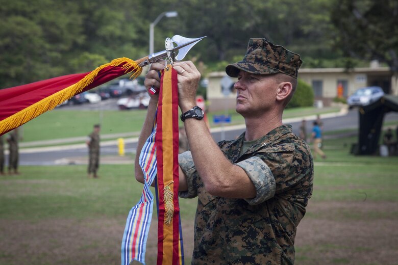 Col. Michael Styskal, the 3rd Marine Regiment commanding officer, attaches unit campaign streamers onto the regiment’s colors during a battle colors ceremony for Bougainville Day, Marine Corps Base Hawaii, Nov. 1, 2017. Bougainville Day is the 75th Anniversary of the unit and 74th anniversary of the Battle of Bougainville. The battle happened on Nov. 1, 1943, when 3rd Marines landed at Empress Augusta Bay, Bougainville, to establish a beachhead, fending off thousands of Imperial Japanese soldiers. (U.S. Marine Corps photo by Cpl. Jesus Sepulveda Torres)