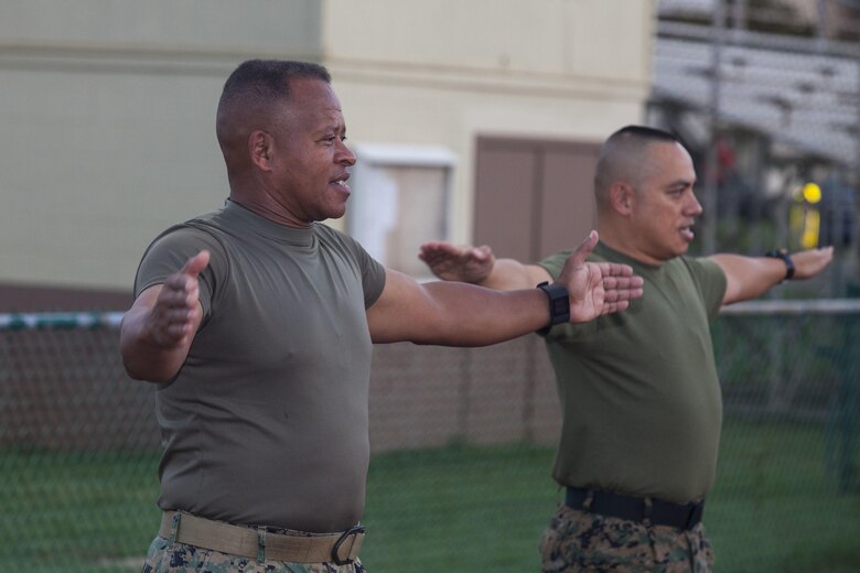 Maj. Gen. Craig Timberlake, the commanding general of 3rd Marine Division, conducts warm-up exercises alongside Sgt. Maj. Vincent Santiago, the division sergeant major, prior to a motivational unit run to commemorate Bougainville Day, Marine Corps Base Hawaii, Nov. 1, 2017. Bougainville Day is the 75th Anniversary of the unit and 74th anniversary of the Battle of Bougainville. The battle happened on Nov. 1, 1943, when 3rd Marines landed at Empress Augusta Bay, Bougainville, to establish a beachhead, fending off thousands of Imperial Japanese soldiers. (U.S. Marine Corps photo by Cpl. Jesus Sepulveda Torres)