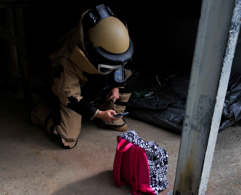 Tech. Sgt. Melissa Aubrey, 315th Civil Engineer Squadron Explosive Ordnance Disposal craftsman, documents the training scenario at the Joint Base Charleston Naval Weapons Station EOD range, Nov. 2, 2017.