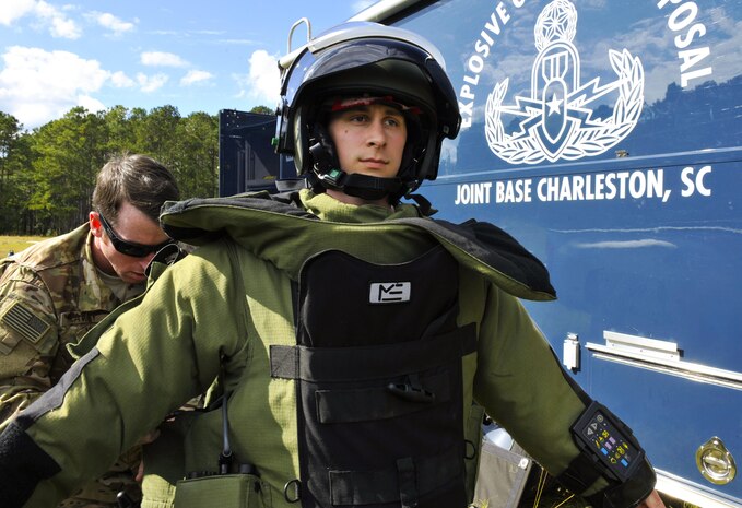 Tech. Sgt. Brenden McCavey, left, 315th Civil Engineer Squadron Explosive Ordnance Disposal craftsman, assists Senior Airman Matthew Koser, right, 315th CES EOD apprentice, with putting on a bomb suit at the Joint Base Charleston Naval Weapons Station EOD range, S.C., Nov. 2, 2017.