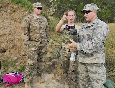 Senior Master Sgt. Tracy Passerotti, left, 628th Civil Engineer Squadron Explosive Ordnance Disposal flight chief, Tech. Sgt. Melissa Aubrey, middle, 315th CES EOD craftsman and Lt. Col. Garrett Stumb, right, 315th CES EOD flight commander inspect an exploded bomb at the Joint Base Charleston Naval Weapons Station EOD range, S.C., Nov. 2, 2017.