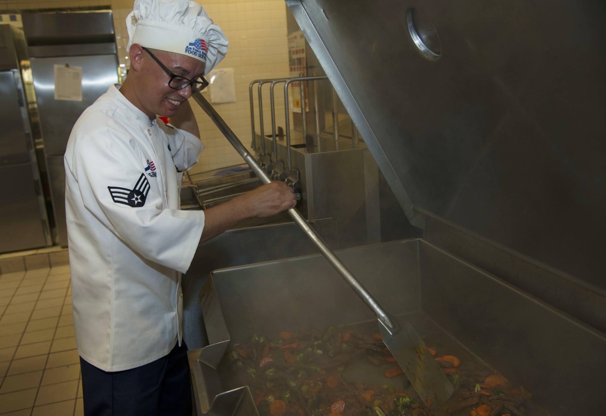 U.S. Air Force Senior Airman Edward Santiago, a food services journeyman assigned to the 6th Force Support Squadron, mixes a stir fry at MacDill Air Force Base, Fla., Nov. 8, 2017.