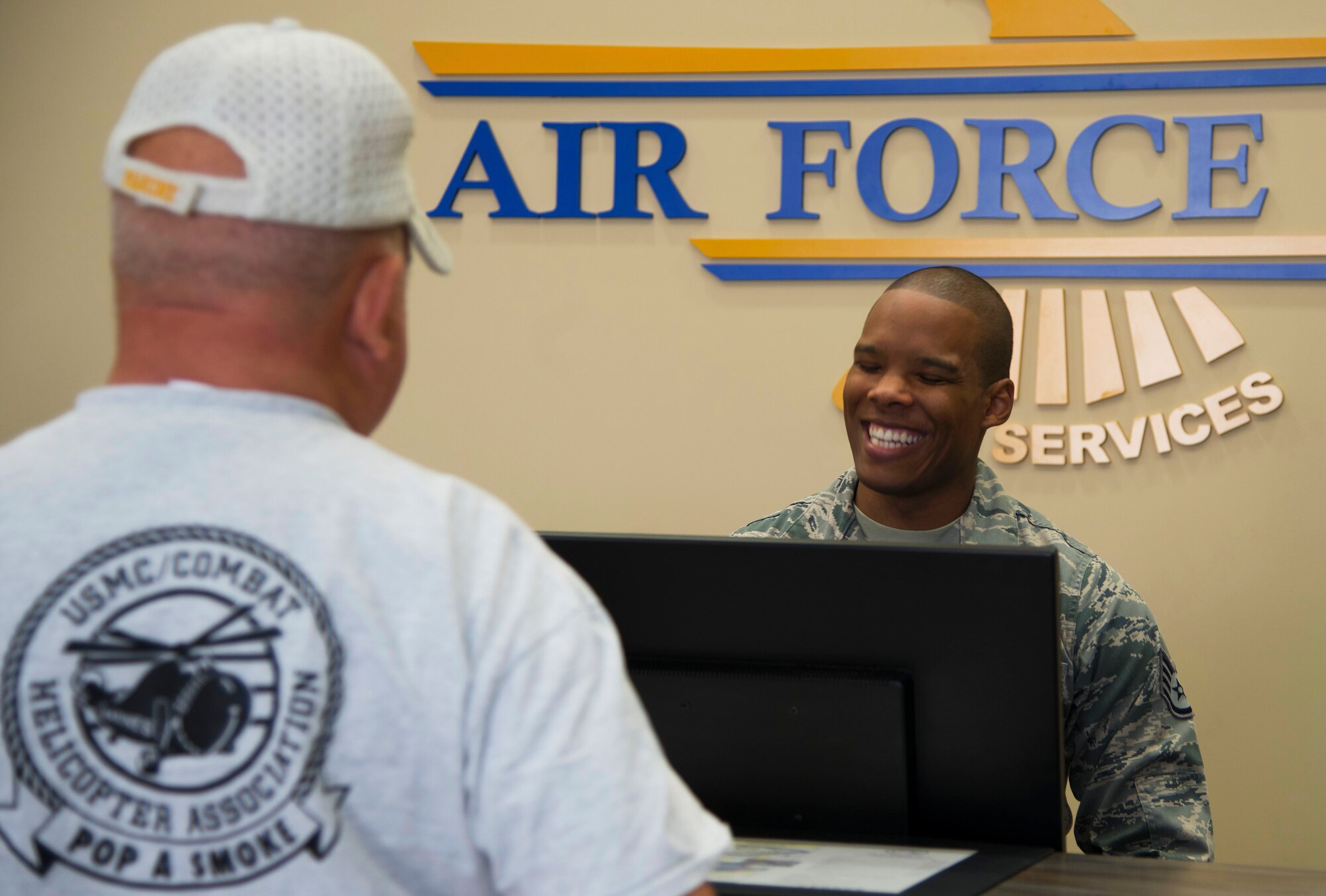 U.S. Air Force Staff Sgt. Deshaun Jones, the NCO in charge of front desk lodging assigned to the 6th Force Support Squadron, assists a MacDill Inn customer at MacDill Air Force Base, Fla., Nov. 8, 2017.