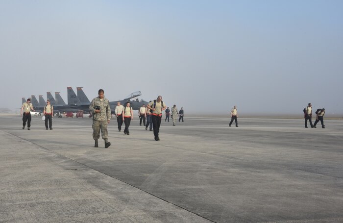 Airmen from Shaw Air Force Base, S.C., and Mountain Home Air Force Base, Idaho, begin their day of work shortly after being dropped off on the flight line at Tyndall Air Force Base, Fla.