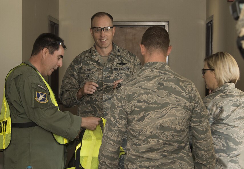 U.S. Air Force Col. Matthew Leard, vice commander for the 60th Air Mobility Wing, and Chief Master Sgt. Erika Scofield, group superintendent for the 60th Mission Support Group, are issued safety gear prior to Defender Annual Refresher crucible training, Oct. 27, Travis Air Force Base, Calif.  60th SFS team members go through a 30-day period of intense training for the DART program. The teams of specially trained security forces personnel are dedicated to providing security for terrorist and criminal threat areas.