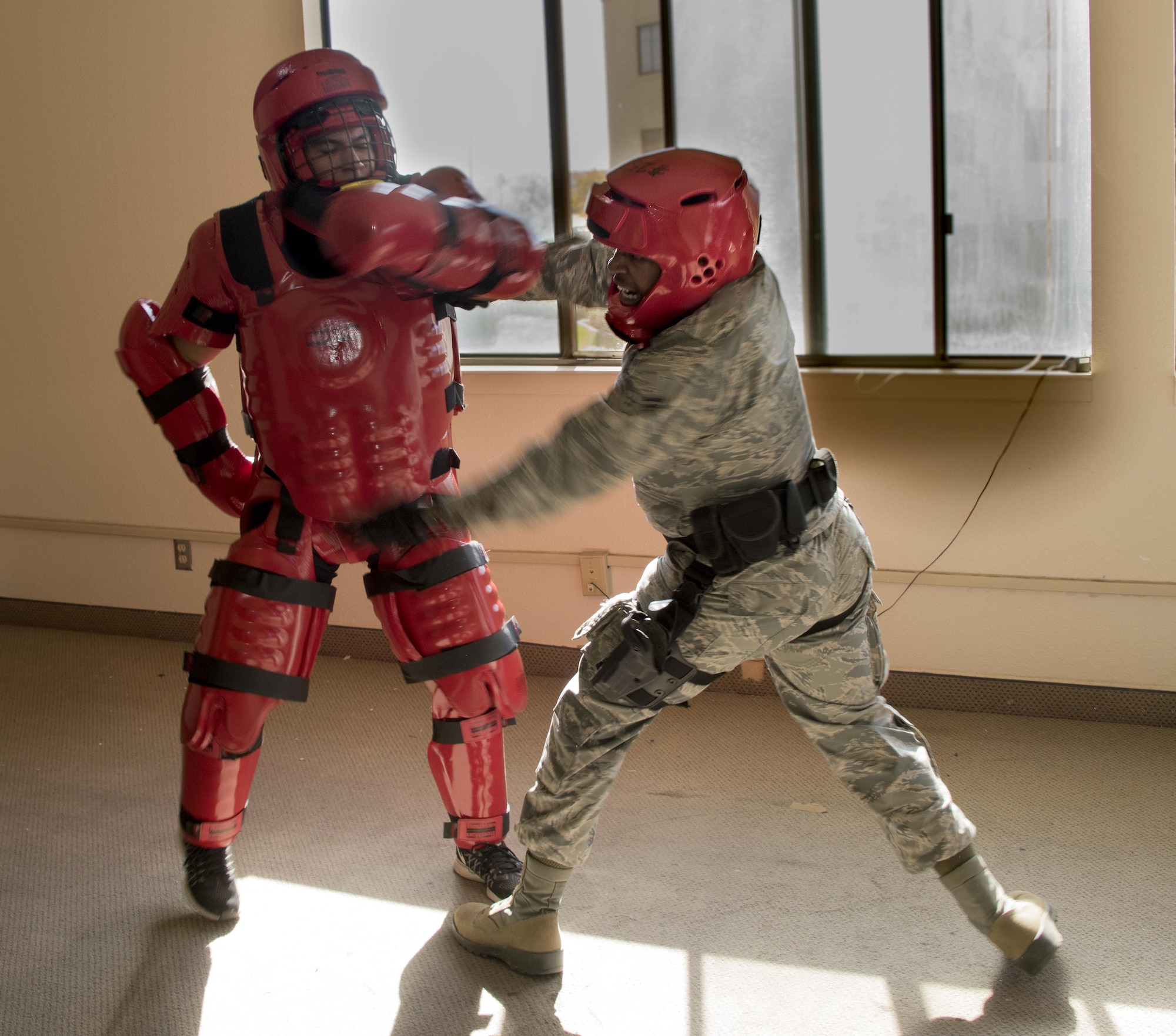 U.S. Air Force Airman 1st Class Christopher Boone, 60th Security Forces Squadron, tries to take down the “Redman” during Defender Annual Refresher crucible training, Oct. 27, Travis Air Force Base, Calif.  60th SFS team members go through a 30-day period of intense training for the DART program. The teams of specially trained security forces personnel are dedicated to providing security for terrorist and criminal threat areas.