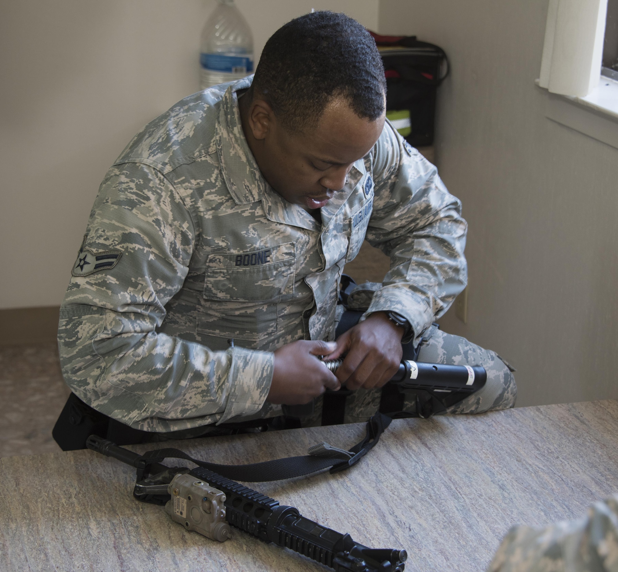 U.S. Air Force Airman 1st Class Christopher Boone with 60th Security Forces Squadron, has minutes to dissemble and reassemble a weapon while answering questions being rapidly asked by an instructor during Defender Annual Refresher crucible training, Oct. 27, Travis Air Force Base, Calif.  60th SFS team members go through a 30-day period of intense training for the DART program. The teams of specially trained security forces personnel are dedicated to providing security for terrorist and criminal threat areas.