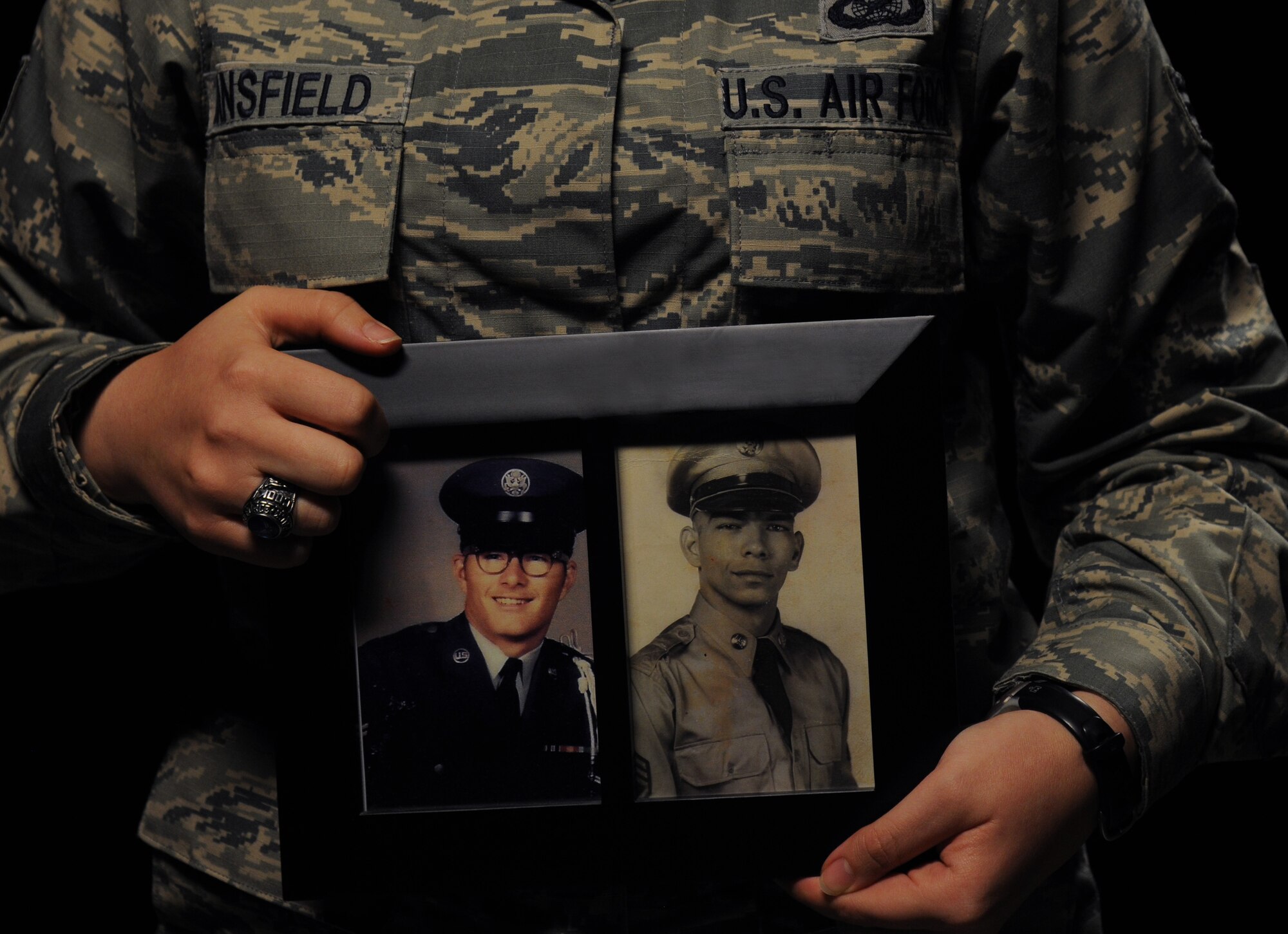 Senior Airman Holly Mansfield, 81st Training Wing Public Affairs photojournalist, holds a photo of her father, James Cook Jr., and grandfather, U.S. Army Master Sgt. retired James Cook Sr., Nov. 9, 2017, on Keesler Air Force Base, Mississippi. As a third generation military member, Mansfield carries on the legacy of service started by her grandfather who joined the Army in 1956 and her father who served in the Air Force during the Vietnam War. (U.S. Air Force photo by Senior Airman Holly Mansfield)