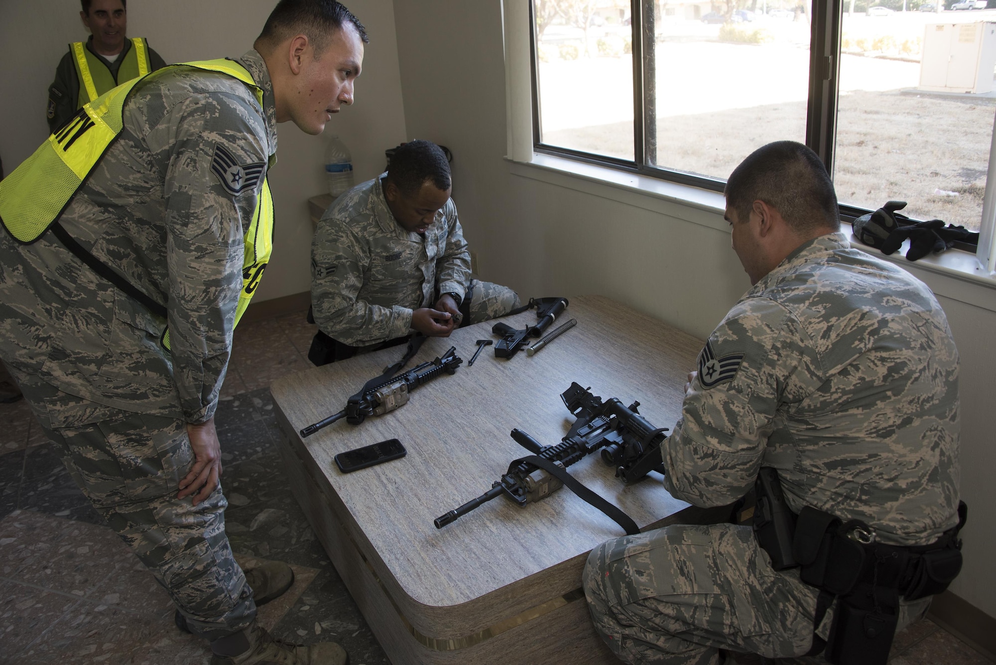 U.S. Air Force Airman 1st Class Christopher Boone, and Staff Sgt. Jamie Tovar, both with 60th Security Forces Squadron, have minutes to dissemble and reassemble a weapon while answering questions being rapidly asked by an instructor during Defender Annual Refresher crucible training, Oct. 27, Travis Air Force Base, Calif.  60th SFS team members go through a 30-day period of intense training for the DART program. The teams of specially trained security forces personnel are dedicated to providing security for terrorist and criminal threat areas.