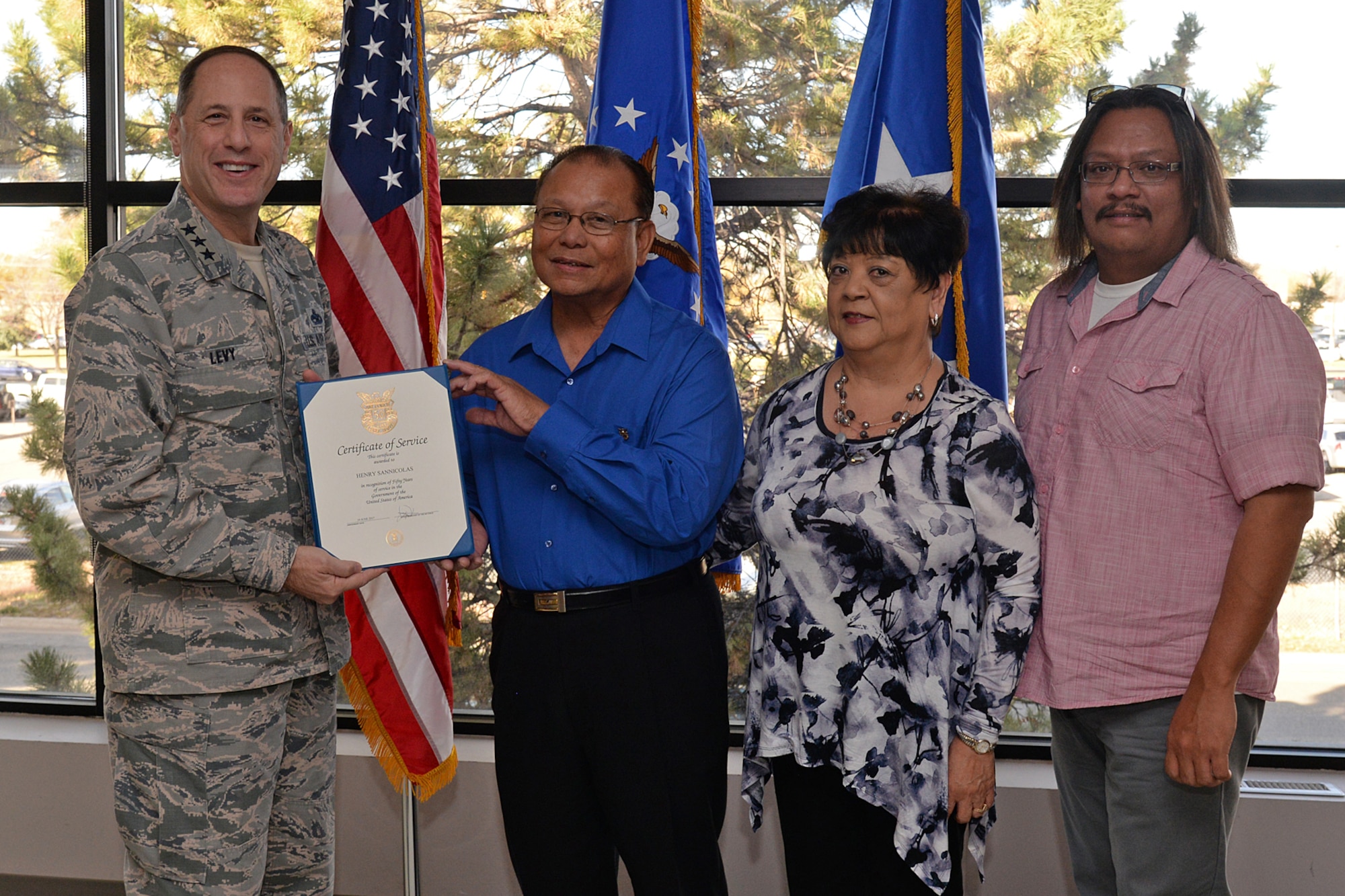 Lt. Gen. Lee K Levy II, Air Force Sustainment Center commander, presents Henry San Nicolas his 50-year service certificate, while his wife Dorothy and son Christopher join him during the presentation on Nov. 2, 2017, at Hill Air Force Base, Utah. (U.S. Air Force Photo by Alex R. Lloyd)