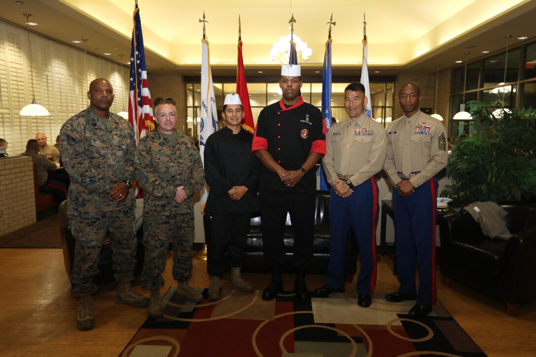 Cpl. Christian Fuentes and Gunnery Sgt. Rudolph Montgomery (center) prepared a special meal hosted by the Moreland Hall Dining Facility, November 8, 2017 aboard Naval Air Station Joint Reserve Base Fort Worth, Texas. The Marine Corps birthday meal was presented by 14th Marine Regiment, 4th Marine Division in honor of all local Marines and to commemorate the 242nd Marine Corps Birthday. Pictured left to right are Sgt. Maj. Karl McCants, the 14th Marines Sergeant Major, Col. Joe Russo, Commanding Officer for 14th Marines, Fuentes, Montgomery, Col. Keven Matthews, Commanding Officer for 8th Marine Corps District, and Sgt. Maj. Troy Nicks, the 8th Marine Corps Sergeant Major.