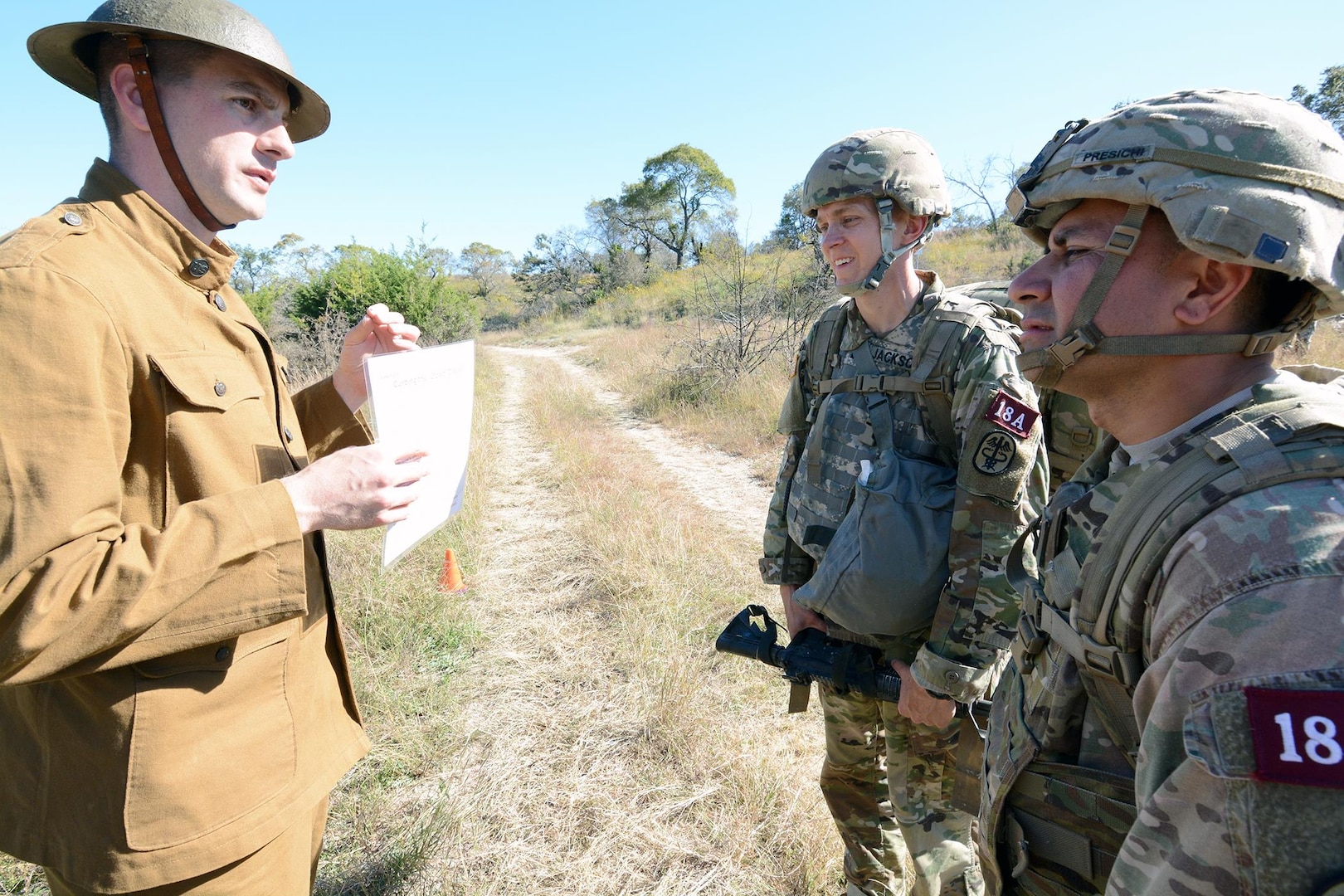 Dressed in WWI period uniform, Staff Sgt.Clint McKinley, AMEDDC&S, dressed in WWI period uniform, briefs Capt.Stona Jackson, 1LT Marco Presichi, Regional Health Command – Europe, on the DNBI / Orienteering lane.