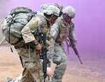 Staff Sgt. Lionel Semon and Sgt. Rolando Fender, assigned to the Airborne and Ranger Training Brigade drag an injured Soldier out of harms way during the tactical combat casualty care (TC3) lane.