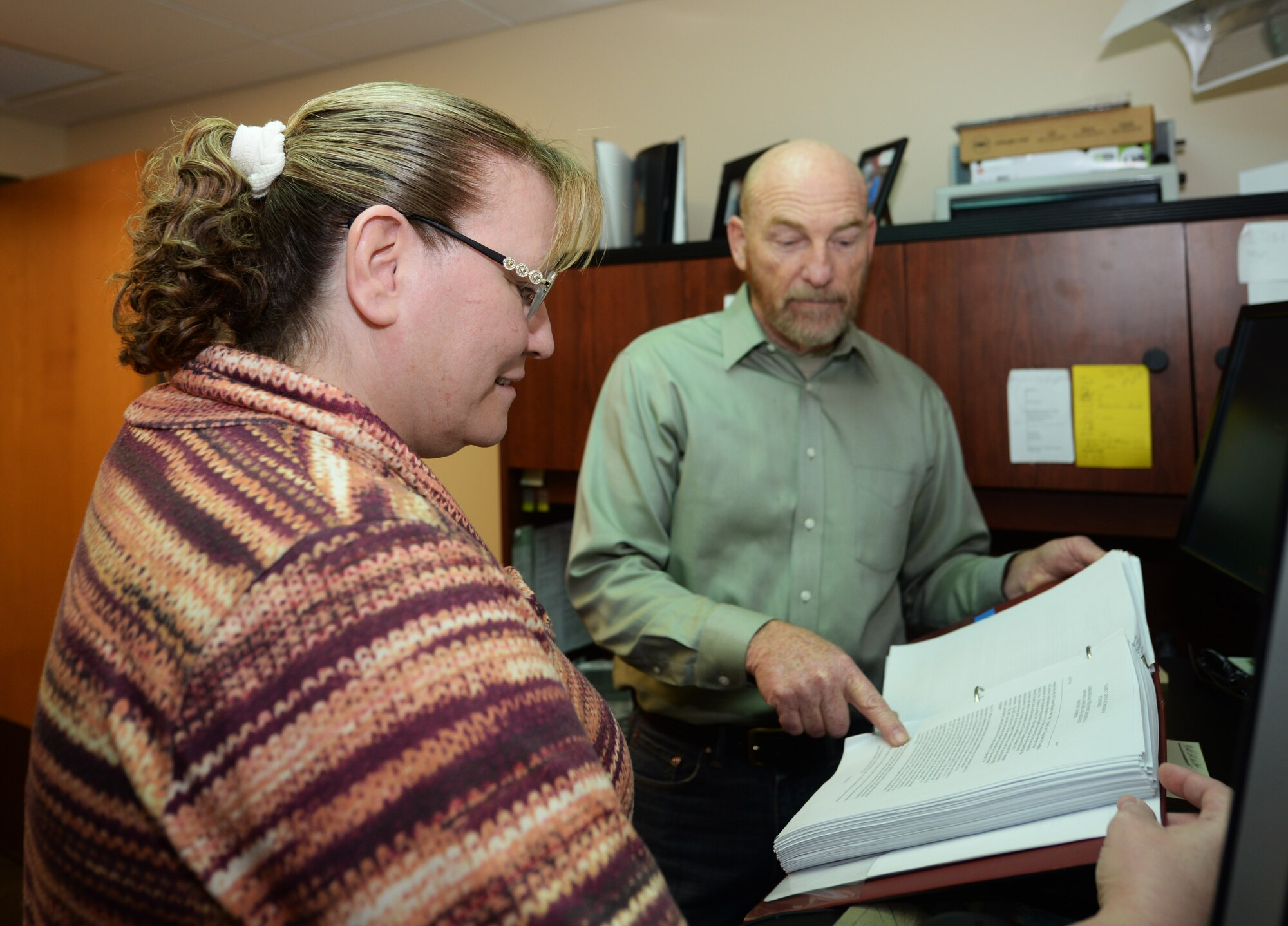 Kimberly Kohler, the Family Advocacy outreach manager, and David Butler, a Family Advocacy Program Assistant with the 28th Medical Group, look over instructions at Ellsworth Air Force Base, S.D., Nov. 8, 2017. The Family Advocacy Program is located inside the Mental Health Clinic, where the group meets with individuals who need help or advice with marriage, finances or new families. (U.S. Air Force photo by Airman 1st Class Thomas Karol)
