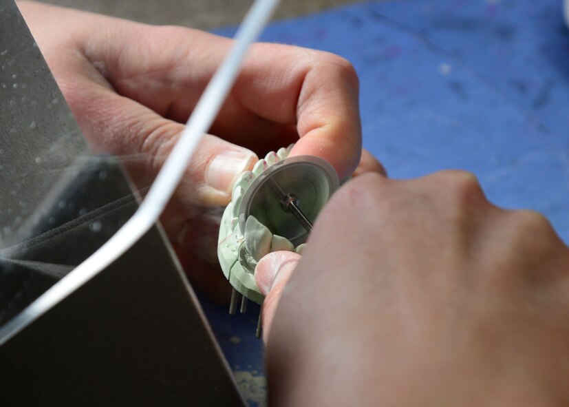 Staff Sgt. Maria Schinella, 14th Medical Operations Squadron dental laboratory technician, carves a mold of teeth Nov. 3, 2017, on Columbus Air Force Base, Mississippi. The mold is used to help dental technicians fit dentures, posts and implants. (U.S. Air Force photo by Airman 1st Class Beaux Hebert)