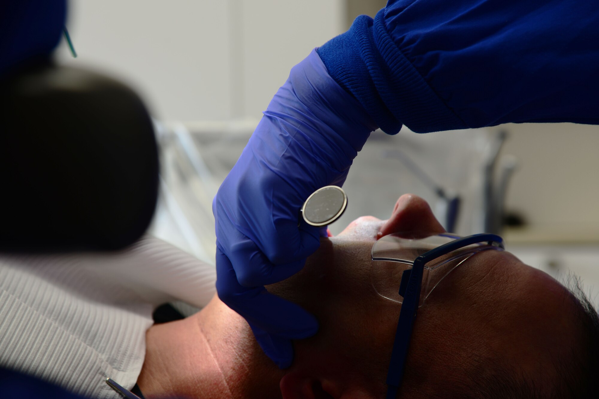 Capt. John Ensley, 14th Medical Operations Squadron General Dentist, operates on a patient Nov. 3, 2017, on Columbus Air Force Base, Mississippi. The 14th MDOS Dental Flight is capable of performing simple dental procedures. (U.S. Air Force photo by Airman 1st Class Beaux Hebert)