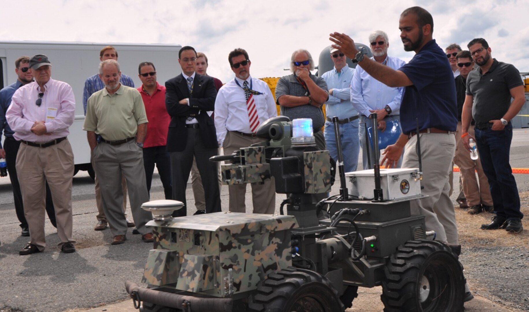 IMAGE:DAHLGREN, Va. (Sept. 12, 2017) - Navy scientist Jamshaid 'JD' Chaudhry briefs visitors on the Weaponized Autonomous System Prototype (WASP) after the Sly Fox Mission 22 demonstration held at Naval Surface Warfare Center Dahlgren Division. The demonstration featured the capabilities of the Collaborative Aerial Network for the Autonomous Remote Engagement System (CANARES) rapid prototyping technology developed by Mission 22 junior scientists and engineers. CANARES consists of an unmanned aerial vehicle, unmanned ground vehicle, and a command and control station.