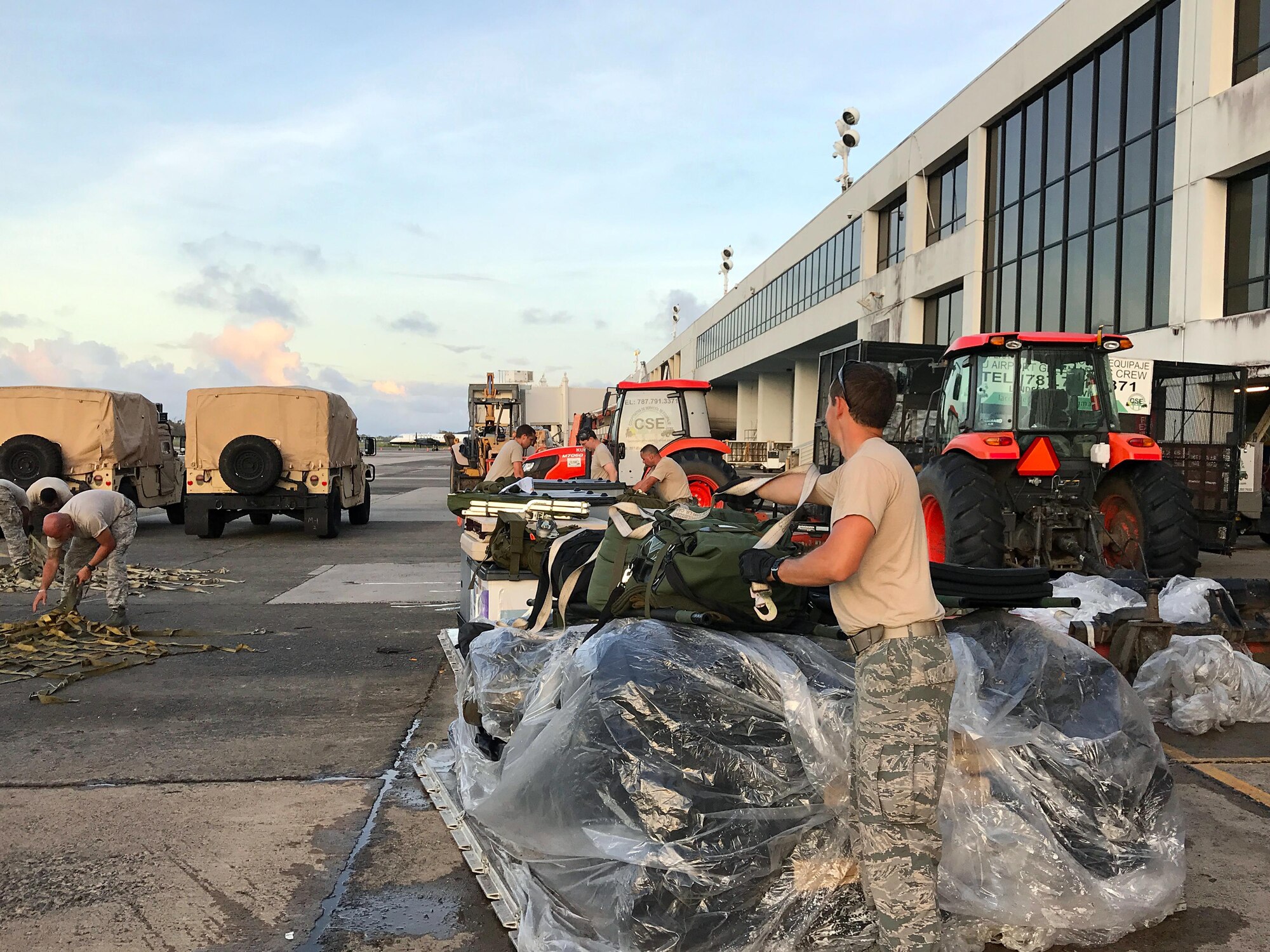 Members of the Disaster Aeromedical Staging Flight (DASF) organize their supplies after unloading at the Luis Muñoz Marín International Airport in San Juan, Puerto Rico. The DASF brought transport vehicles, generators, food, water, medical equipment and other supplies necessary to complete their mission of supporting patients in response to a disaster.