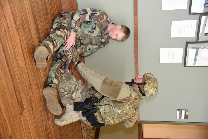Airman checking on injured person