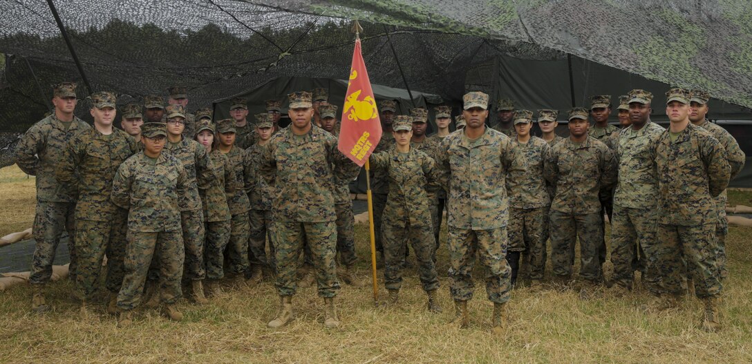 Marines with Food Service Company, Headquarters Regiment, 2nd Marine Logistics Group pose for a group photo in front of the expeditionary dining facility during the Maj. Gen. William Pendleton Thompson Hill Awards for food service excellence competition aboard Camp Lejeune, N.C., Nov. 8, 2017. The W.T.P. Hill award recognizes the best mess hall operations in the entire Marine Corps for outstanding performance.  (U.S. Marine Corps photo by Lance Cpl. Leynard Kyle Plazo)