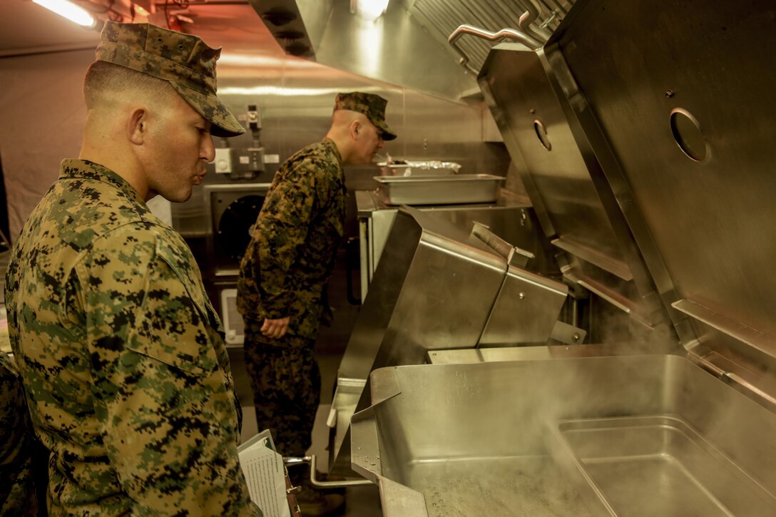 Marines with 2nd Marine Logistics Group inspect the equipment inside the Expeditionary Field Kitchen during the Maj. Gen. William Pendleton Thompson Hill Awards for food service excellence competition aboard Camp Lejeune, N.C., Nov. 8, 2017. The W.T.P. Hill award recognizes the best mess hall operations in the entire Marine Corps for outstanding performance.  (U.S. Marine Corps photo by Lance Cpl. Leynard Kyle Plazo)