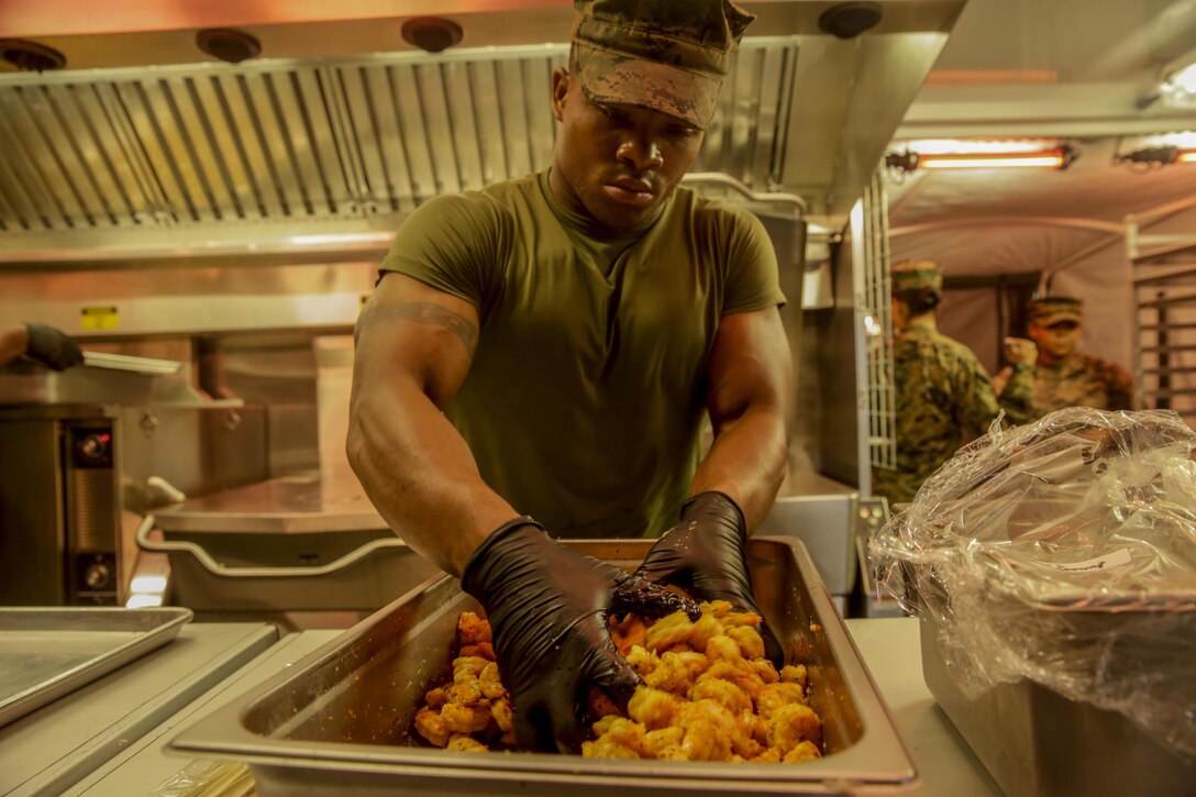 Pfc. Brandon Strong mixes Cajun sauce with shrimp during the Maj. Gen. William Pendleton Thompson Hill Awards for food service excellence competition aboard Camp Lejeune, N.C., Nov. 8, 2017. The W.T.P. Hill award recognizes the best mess hall operations in the entire Marine Corps for outstanding performance.  Pfc. Strong is a food service specialist with Food Service Company, Headquarters Regiment, 2nd Marine Logistics Group. (U.S. Marine Corps photo by Lance Cpl. Leynard Kyle Plazo)