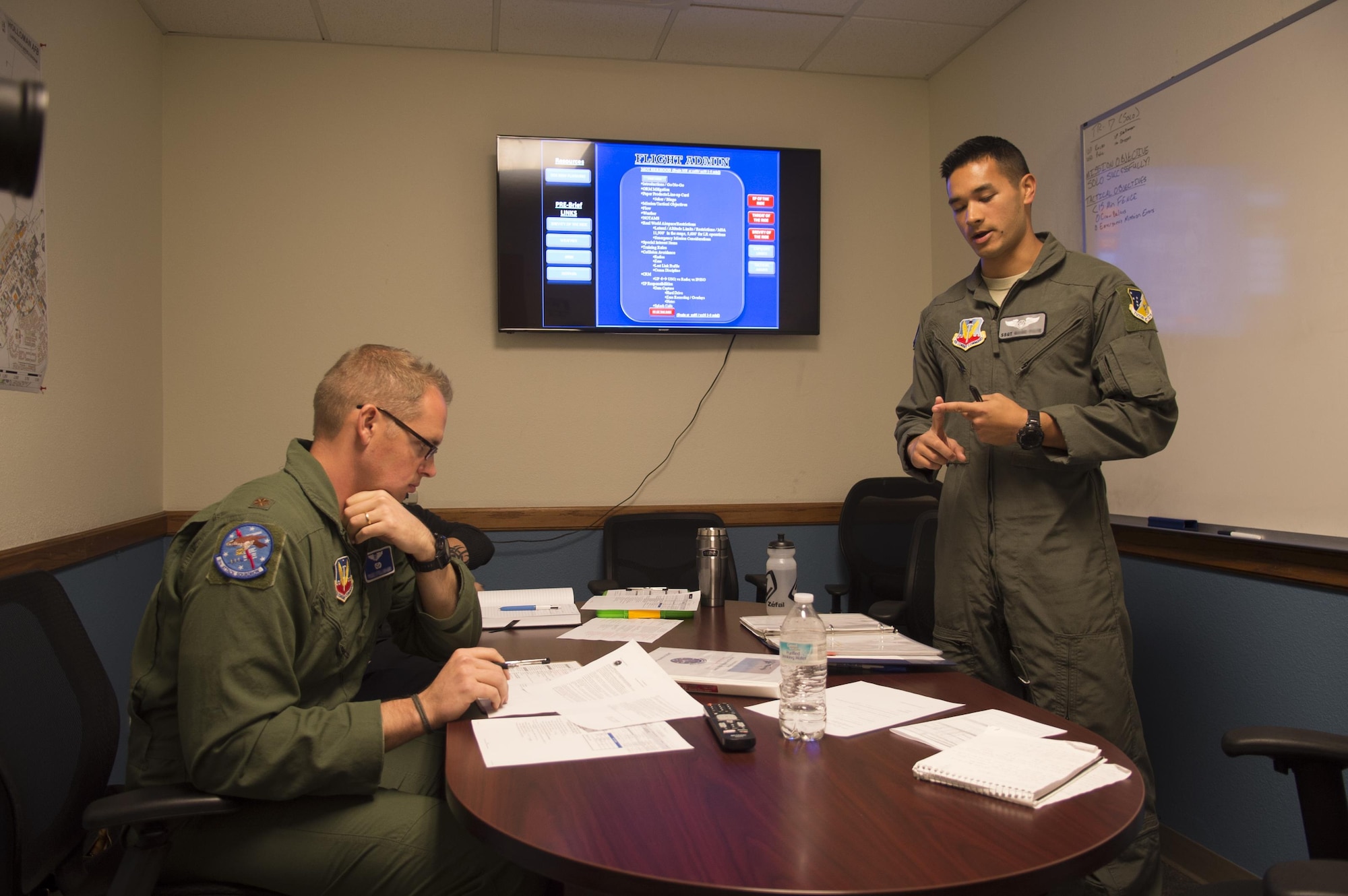 Maj. Jay, 6th Attack Squadron instructor pilot, receives a briefing from a student sensor operator prior to the first solo flight for the aircrew at Holloman Air Force Base, N.M., Nov. 7, 2017. Solo flights build confidence, airmanship and a crew mentality more than academic classroom discussion, or under direct instructor supervision in the cockpit. (U.S. Air Force photo by Tech. Sgt. Amanda Junk)