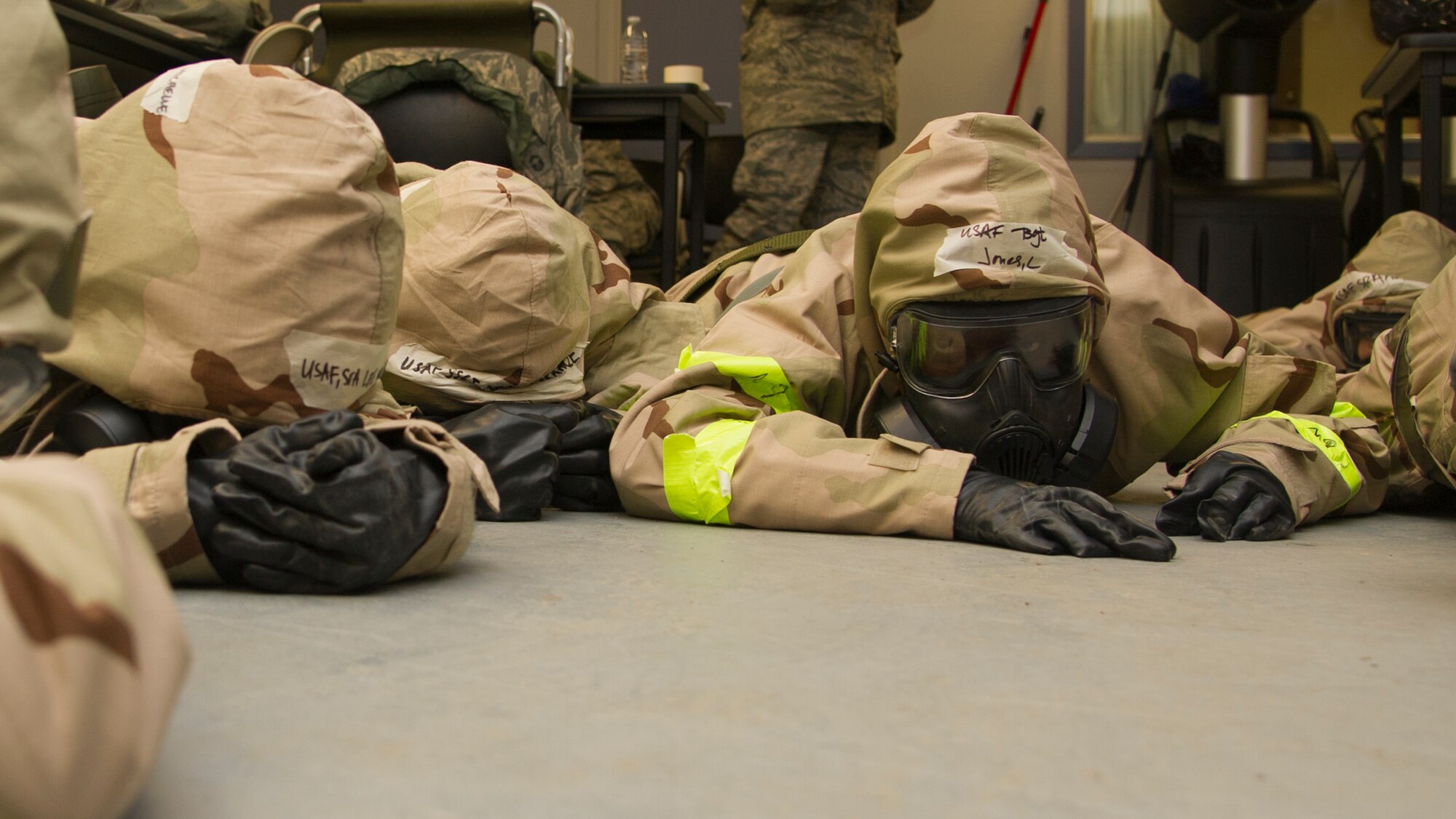 Tech. Sgt. Lether Jones, 940th Aerospace Medicine Squadron medical administration, takes cover during an exercise Nov. 4 at Beale Air Force Base. Airmen stayed low to the ground after their location was hit with a mock strike. (U.S. Air Force photo by Senior Airman Tara R. Abrahams)