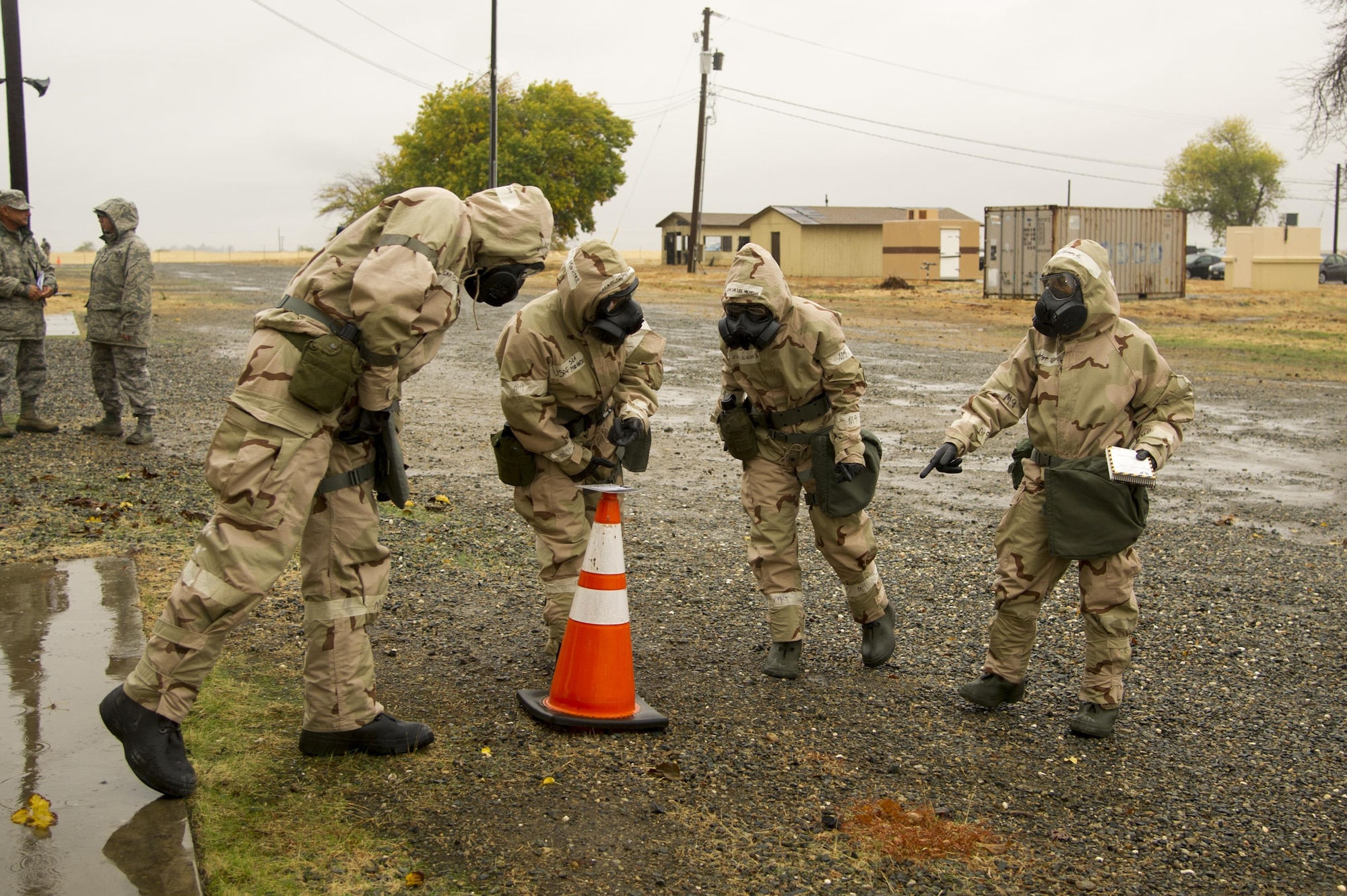 A post-attack reconnaissance team investigates simulated chemical agent detector paper during an exercise Nov. 4 at Beale Air Force Base. The PAR team looked for hazardous agents in the air, as well as unexploded ordnance on the ground. (U.S. Air Force photo by Senior Airman Tara R. Abrahams)