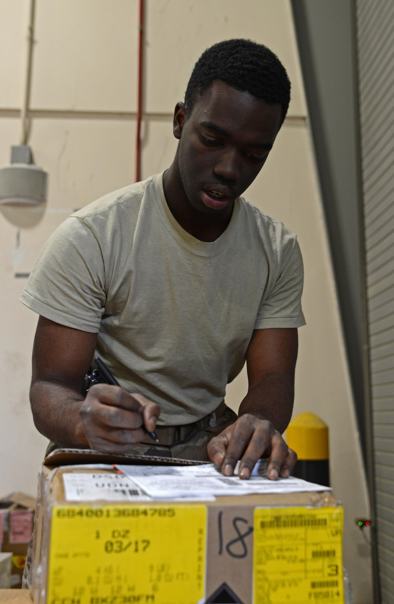 Airman 1st Class Trevis Pridgen, 455th Expeditionary Logistics Readiness Squadron traffic management journeyman, verifies the quantity of a product Nov. 4, 2017 at Bagram Airfield, Afghanistan.