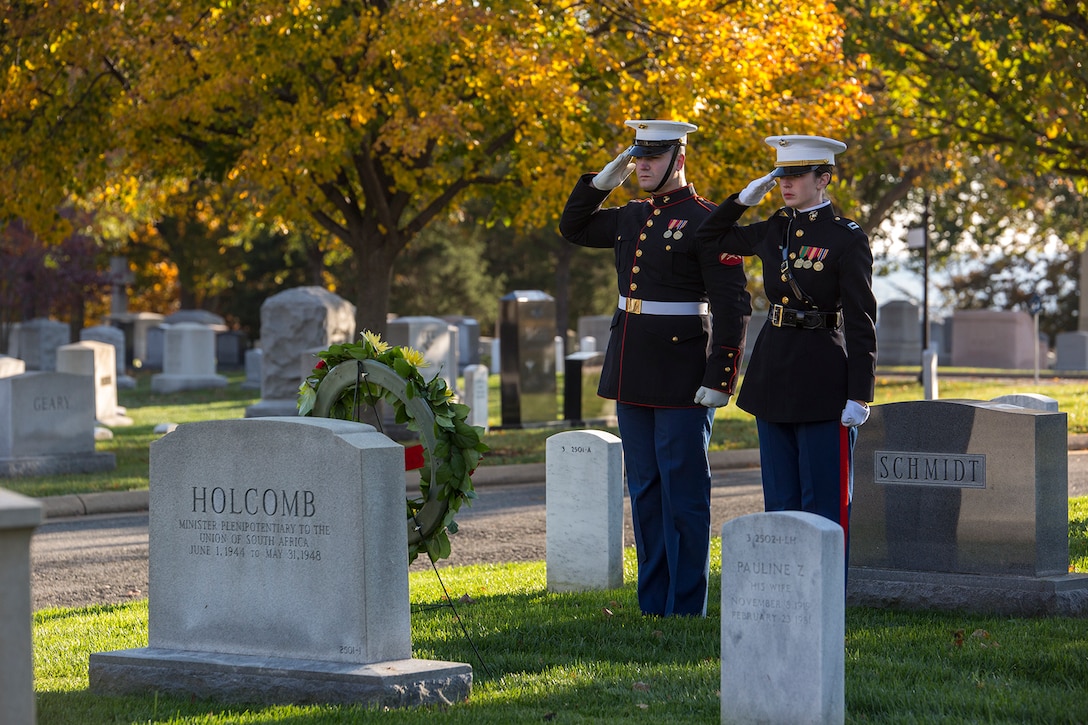 Captain Kaitlin E. Kleiber, officer with Marine Barracks Washington D.C., and Lance Cpl. Luke Givens, Body Bearer, Bravo Company, Marine Barracks Washington D.C., render honors during the playing of Taps after laying a wreath at the gravestone of Gen. Thomas Holcomb, 17th Commandant of the Marine Corps, during a wreath laying ceremony at Arlington National Cemetery, Arlington, Va., Nov. 10, 2017. The wreath laying ceremony is an annual event held to celebrate the U.S. Marine Corps’ birthday and honor those who gave the last full measure of devotion to country and Corps. (Official U.S. Marine Corps photo by Cpl. Robert Knapp/Released)