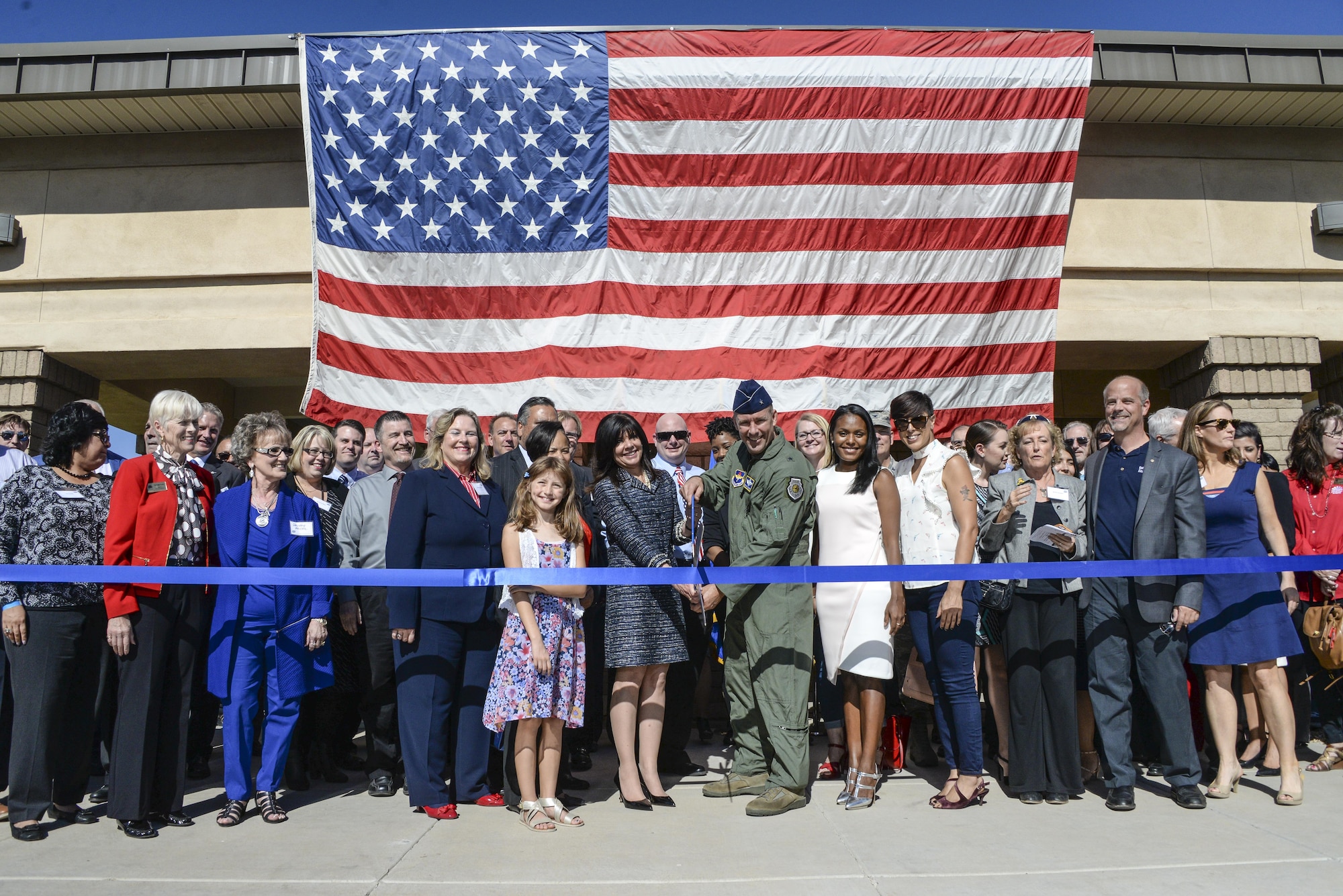 Brig. Gen. Brook Leonard, 56th Fighter Wing commander, and west valley community members cut the ribbon signifying the grand opening of the Military and Veteran Success Center at Luke Air Force Base, Ariz., Nov. 9, 2017. The MVSC is a community supported, case-managed, holistic support center for transitioning service members, veterans, and their dependents. (U.S. Air Force photo/Airman 1st Class Caleb Worpel)
